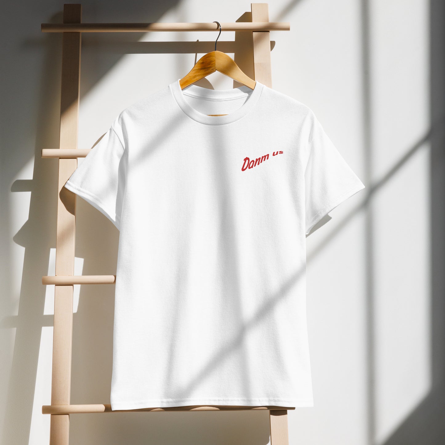 White t-shirt with red 'DANMUS' logo on the chest